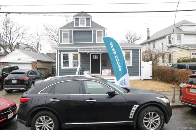 a front view of a house with parking space