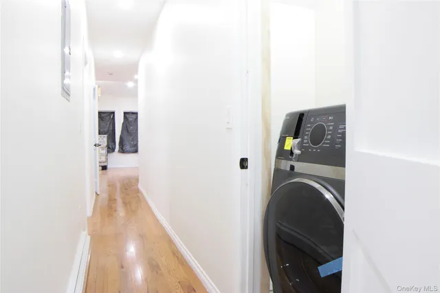 a view of a hallway with washer and dryer