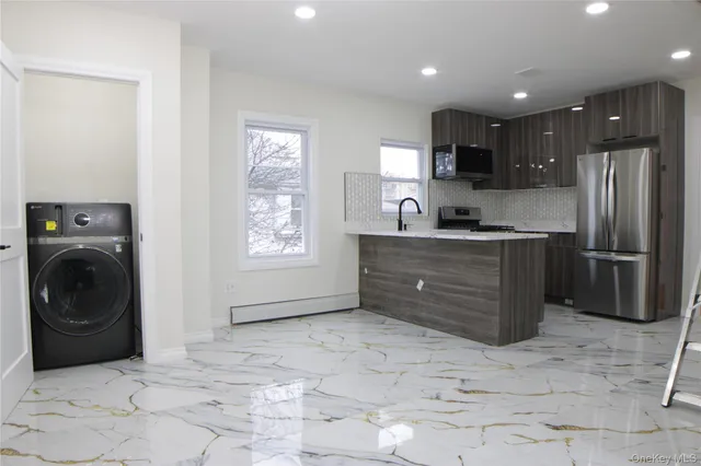 a kitchen with a refrigerator sink and cabinets