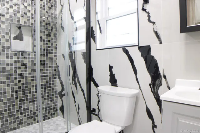 a white toilet sitting next to a shower curtain