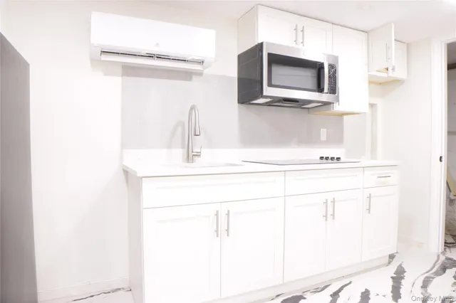 a bathroom with a sink and a microwave