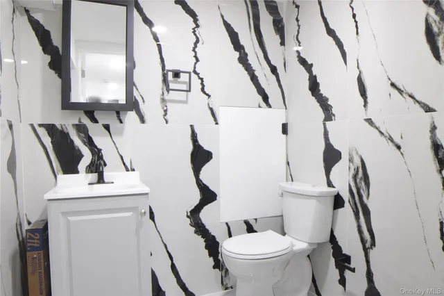 a white toilet sitting next to a small bathroom