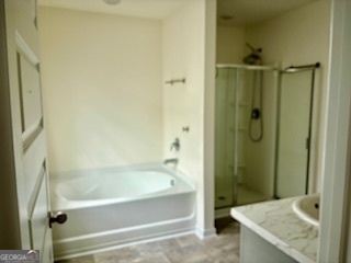 11899 Conrad Circle Hampton, GA 30228 - Photo 11 of 30 a bathroom with a granite countertop bathtub shower sink and toilet