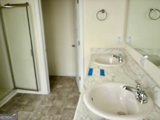 11899 Conrad Circle Hampton, GA 30228 - Photo 13 of 30 a bathroom with a sink and a shower