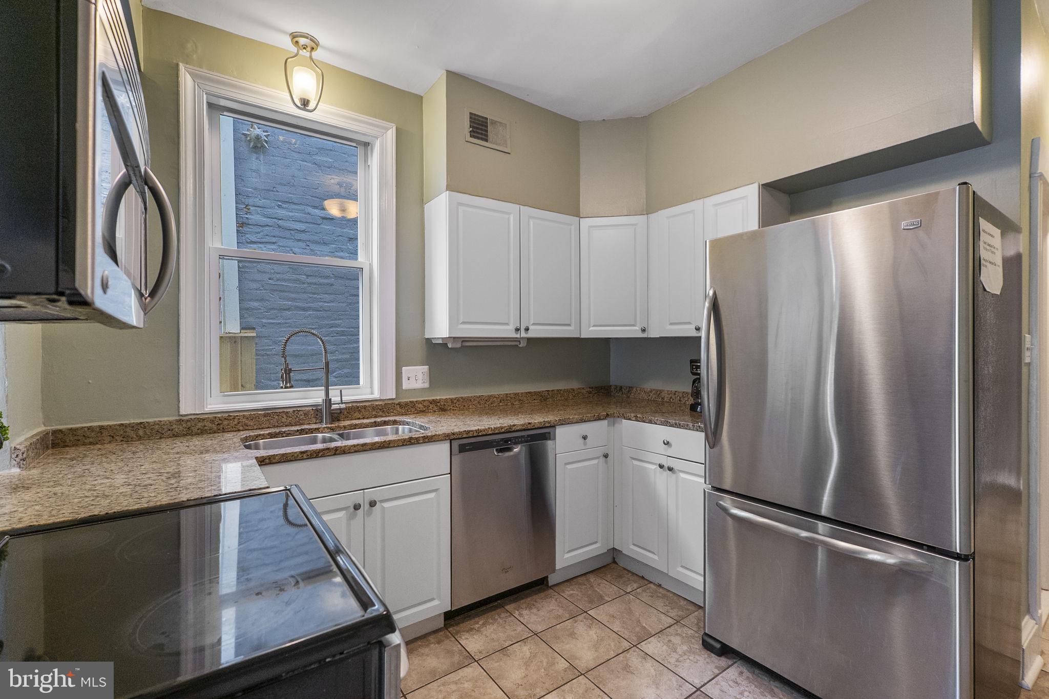 145 D Street Southeast Washington, DC 20003 - Photo 14 of 44 a kitchen with stainless steel appliances granite countertop a refrigerator sink and cabinets