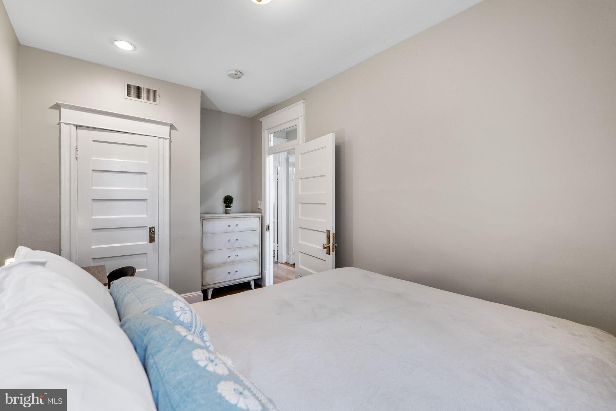 145 D Street Southeast Washington, DC 20003 - Photo 21 of 44 a bedroom with a bed and a ceiling fan