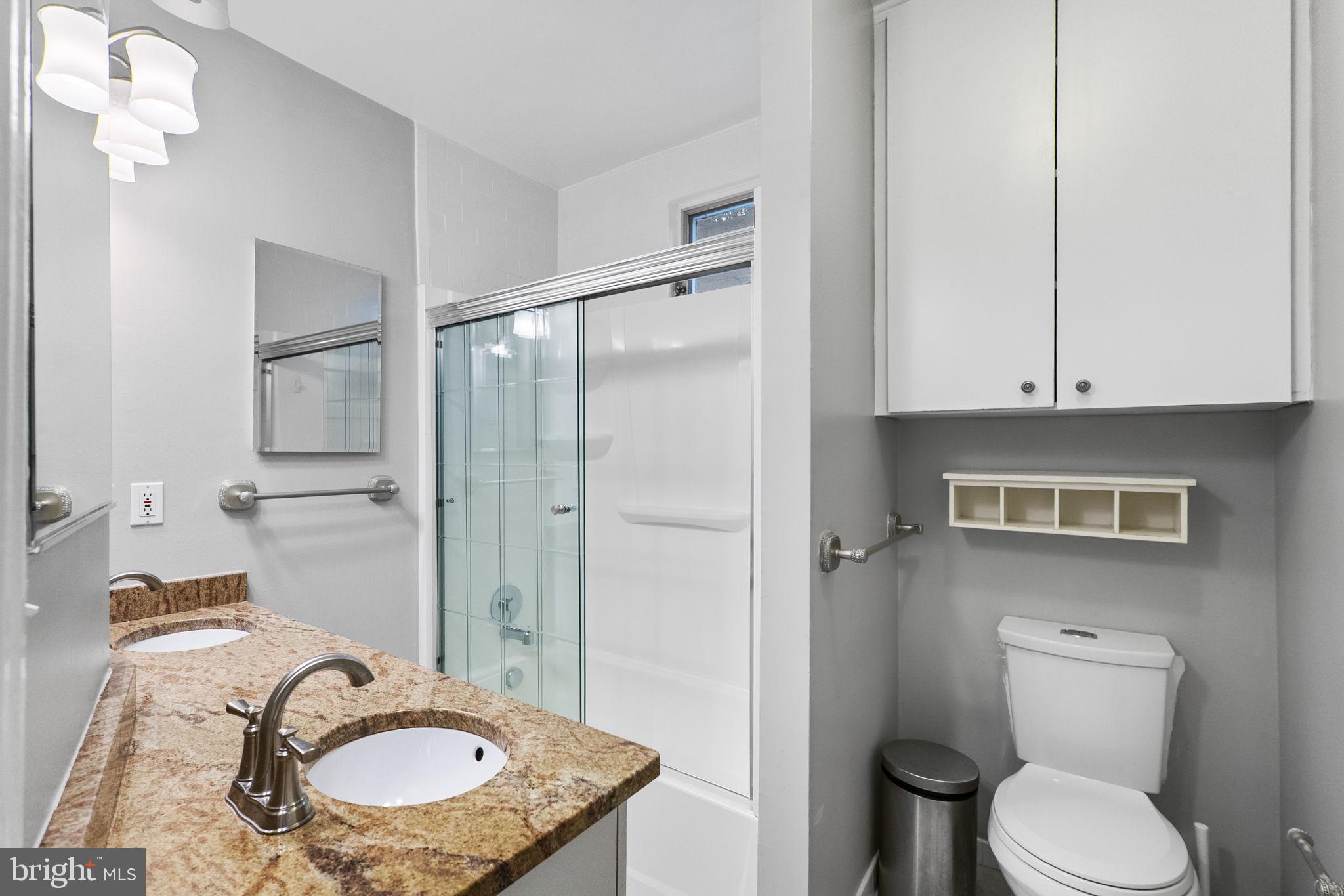 145 D Street Southeast Washington, DC 20003 - Photo 26 of 44 a bathroom with a granite countertop sink toilet and shower