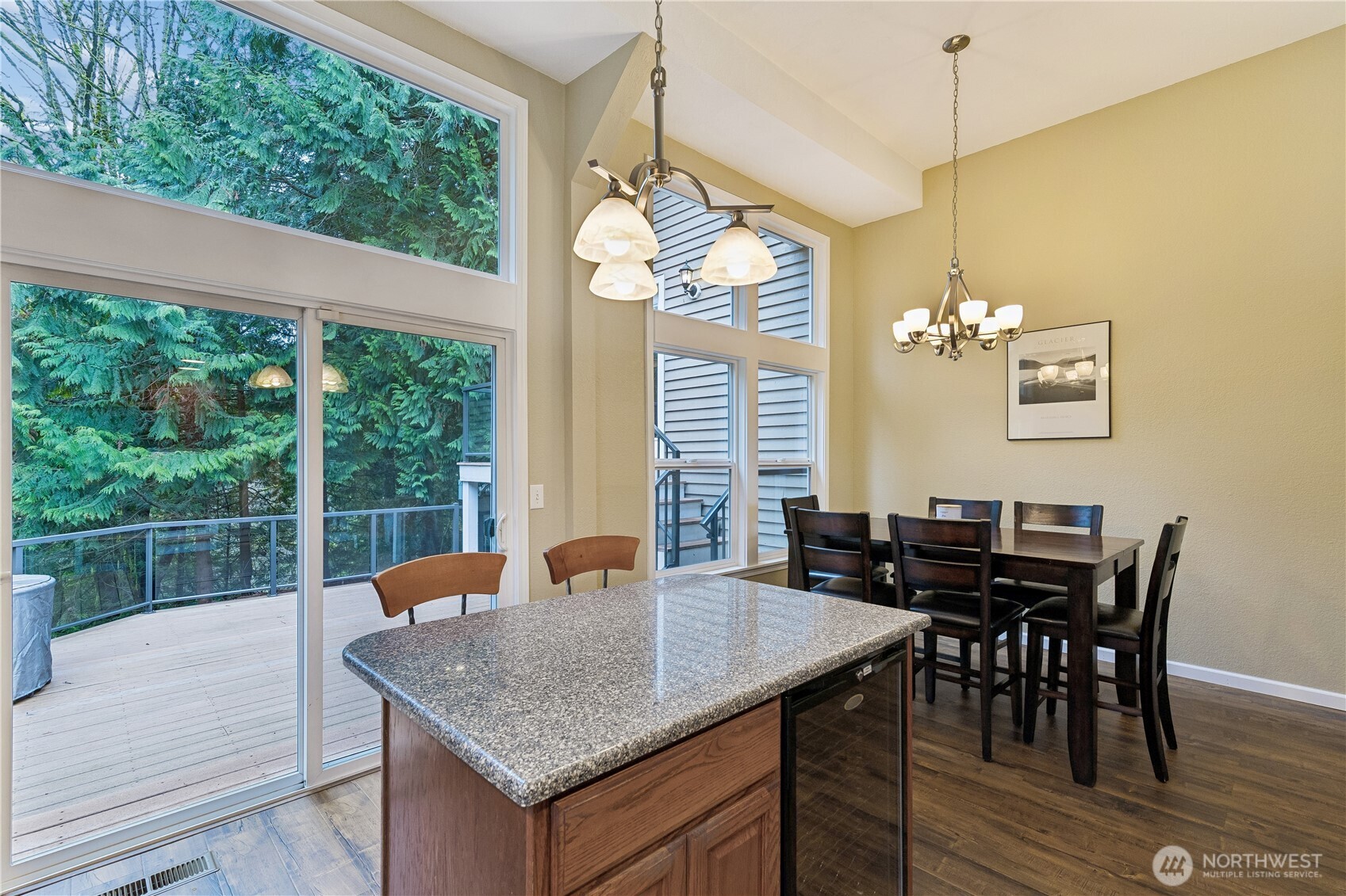 2830 196th Street Southeast Bothell, WA 98012 - Photo 5 of 18 a dining room with wooden floor a chandelier a wooden table and chairs