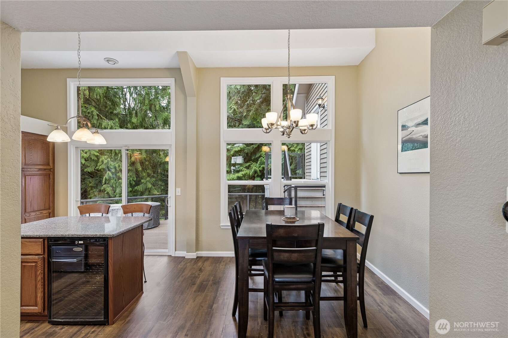 2830 196th Street Southeast Bothell, WA 98012 - Photo 6 of 18 a view of a dining room with furniture large windows and wooden floor
