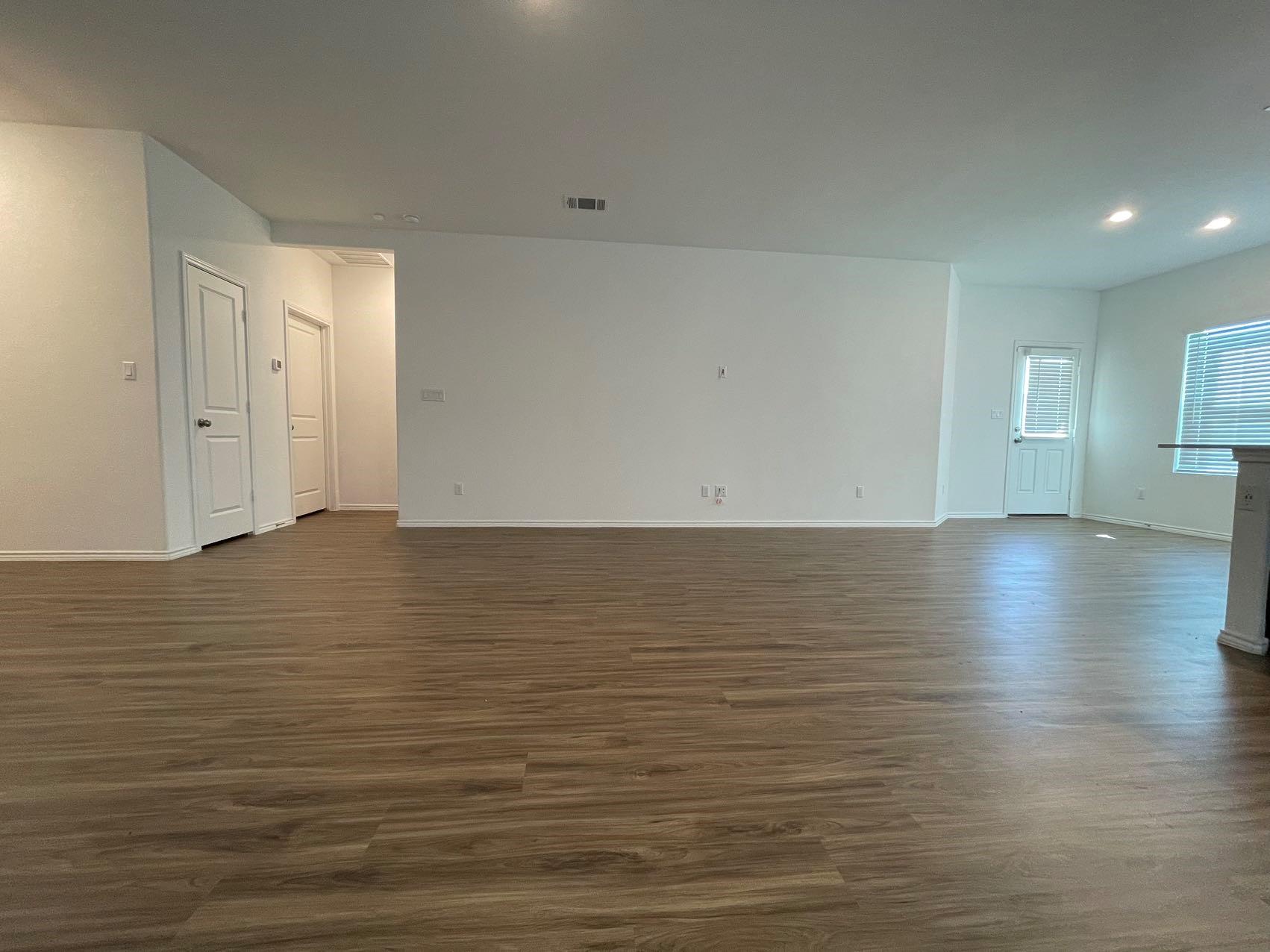 1625 Woolsey Way Leander, TX 78641 - Photo 4 of 17 Spacious interior with wood-style flooring, white walls, and recessed lighting