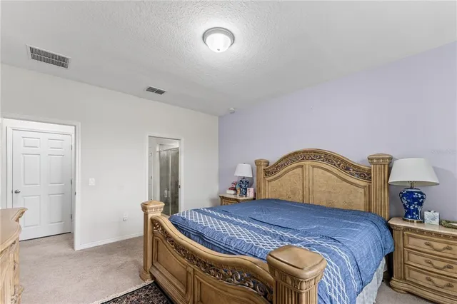 a bedroom with a bed and a mirror