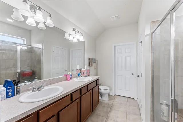 a bathroom with a double vanity sink mirror and