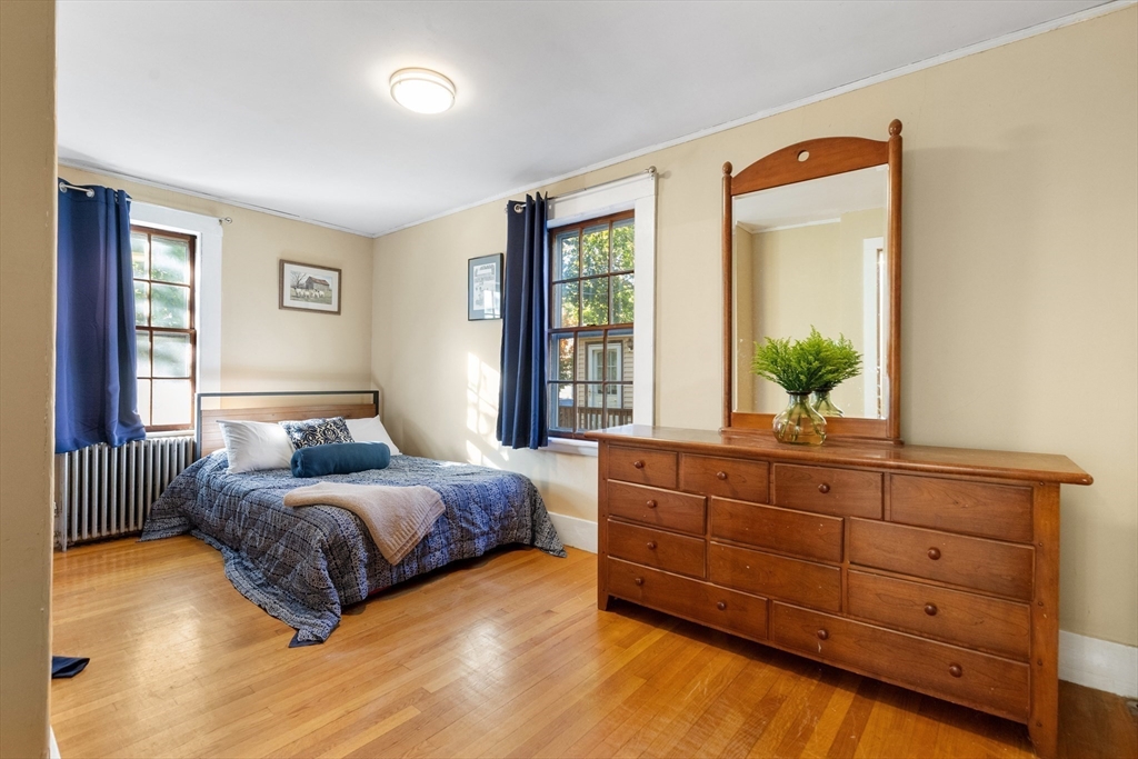 34 Chestnut Street Danvers, MA 01923 - Photo 18 of 33 a bedroom with a bed and window with mirror