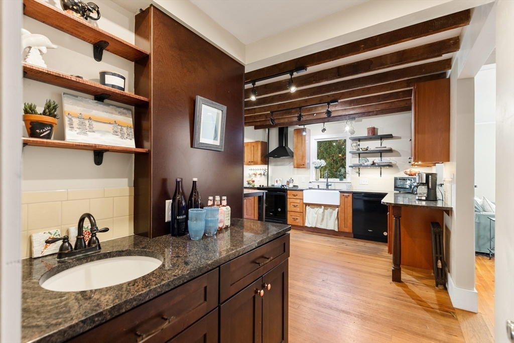 34 Chestnut Street Danvers, MA 01923 - Photo 2 of 33 a kitchen with stainless steel appliances granite countertop a sink stove and wooden cabinets