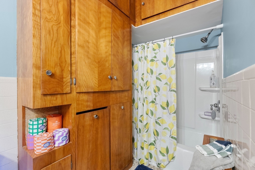 34 Chestnut Street Danvers, MA 01923 - Photo 22 of 33 a bathroom with a shower curtain and a sink