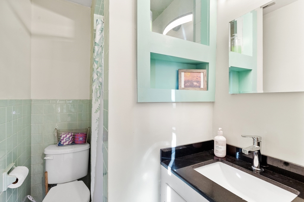 34 Chestnut Street Danvers, MA 01923 - Photo 23 of 33 a bathroom with a toilet a sink and mirror