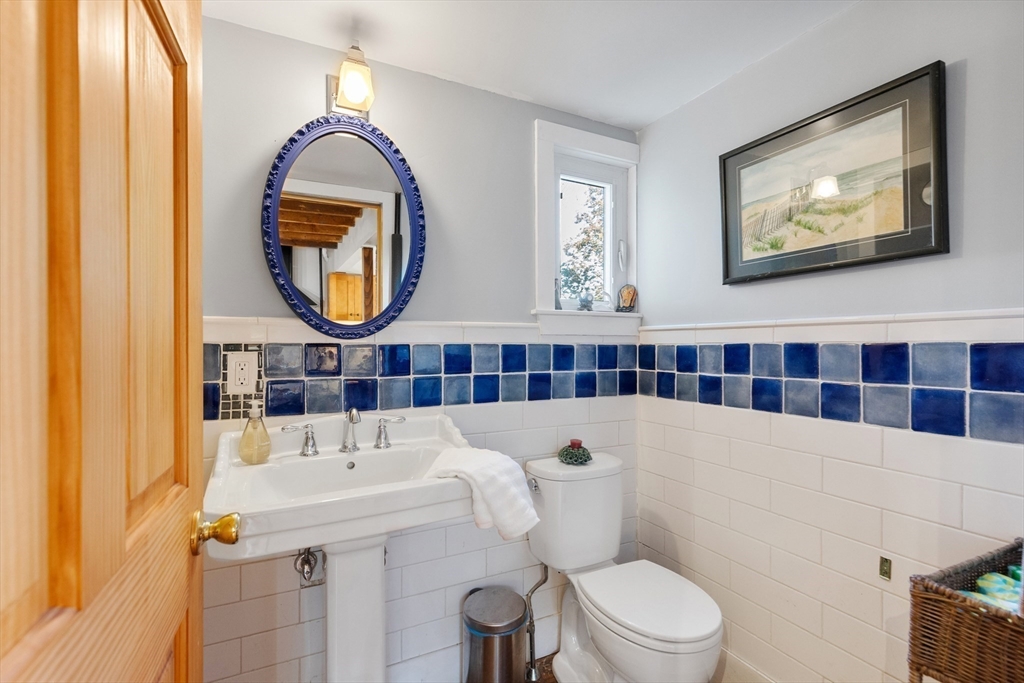 34 Chestnut Street Danvers, MA 01923 - Photo 24 of 33 a bathroom with a sink a toilet and a mirror