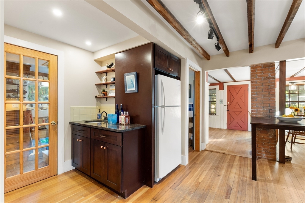 34 Chestnut Street Danvers, MA 01923 - Photo 5 of 33 a kitchen with granite countertop a refrigerator and wooden floor