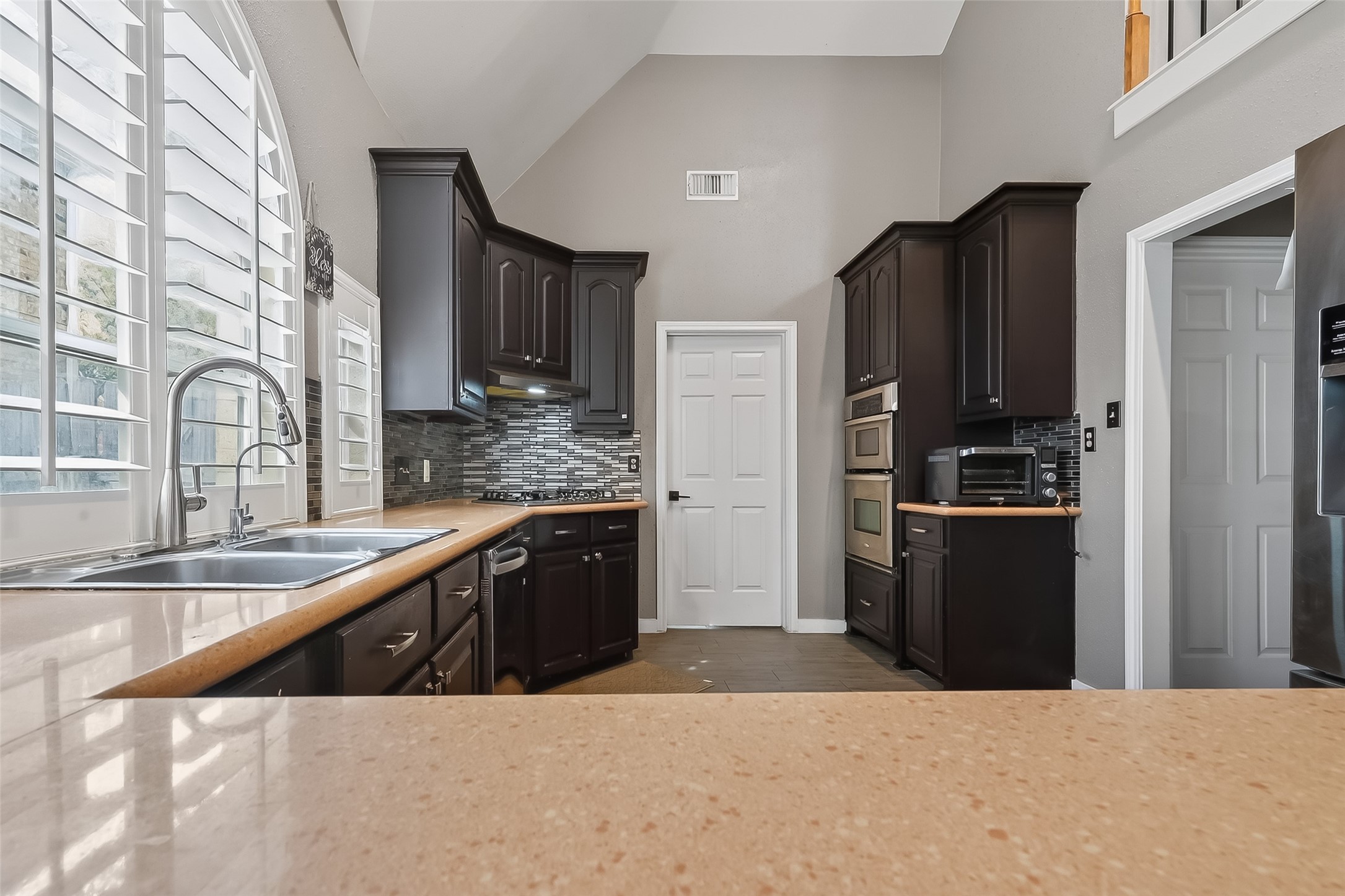 14955 Inverrary Drive Houston, TX 77095 - Photo 18 of 46 a kitchen with stainless steel appliances granite countertop a refrigerator a sink a stove and a wooden cabinets