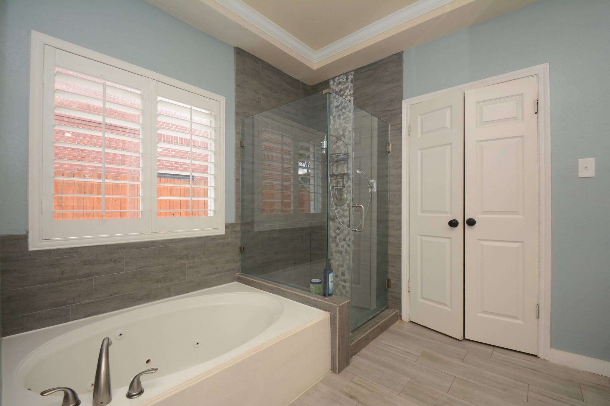 14955 Inverrary Drive Houston, TX 77095 - Photo 23 of 46 a bathroom with a bathtub and shower