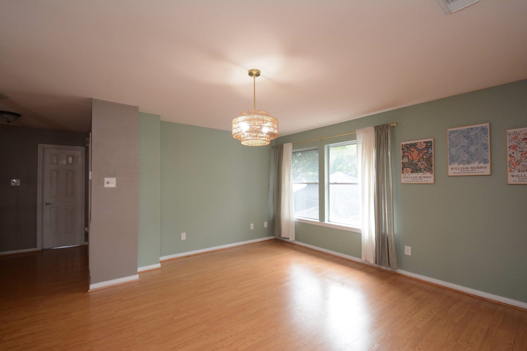 14955 Inverrary Drive Houston, TX 77095 - Photo 27 of 46 an empty room with wooden floor and windows