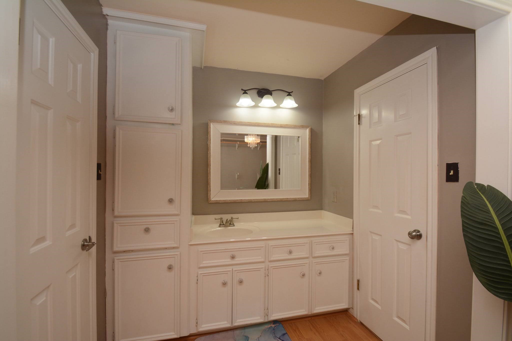 14955 Inverrary Drive Houston, TX 77095 - Photo 30 of 46 a bathroom with a sink and a mirror