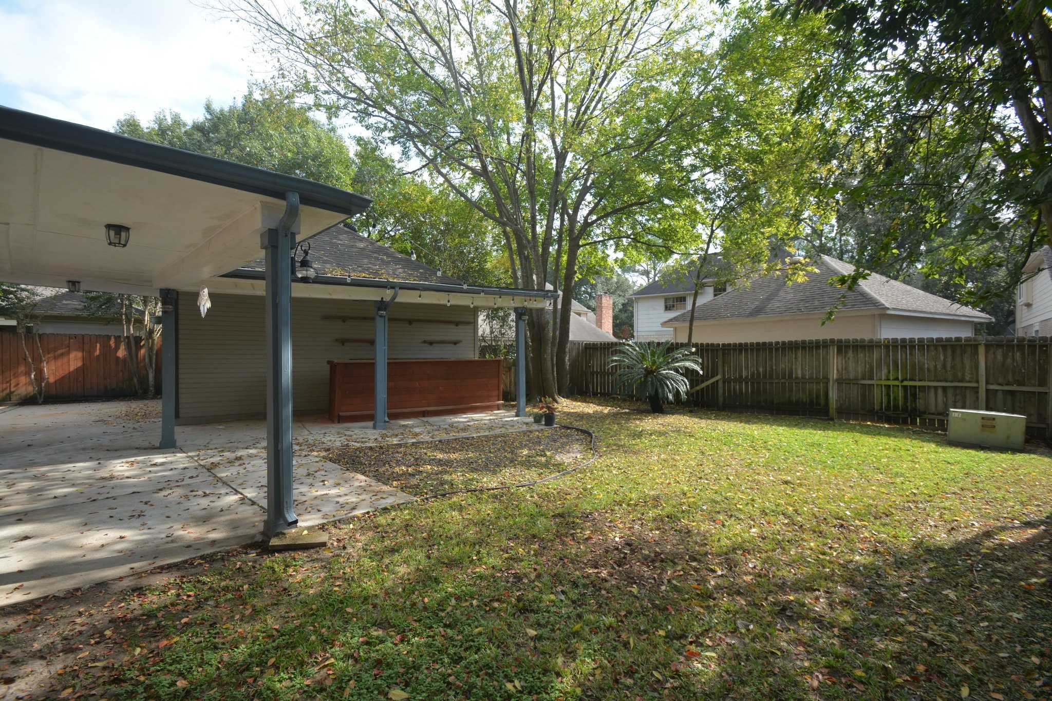14955 Inverrary Drive Houston, TX 77095 - Photo 34 of 46 a backyard of a house with yard and outdoor seating