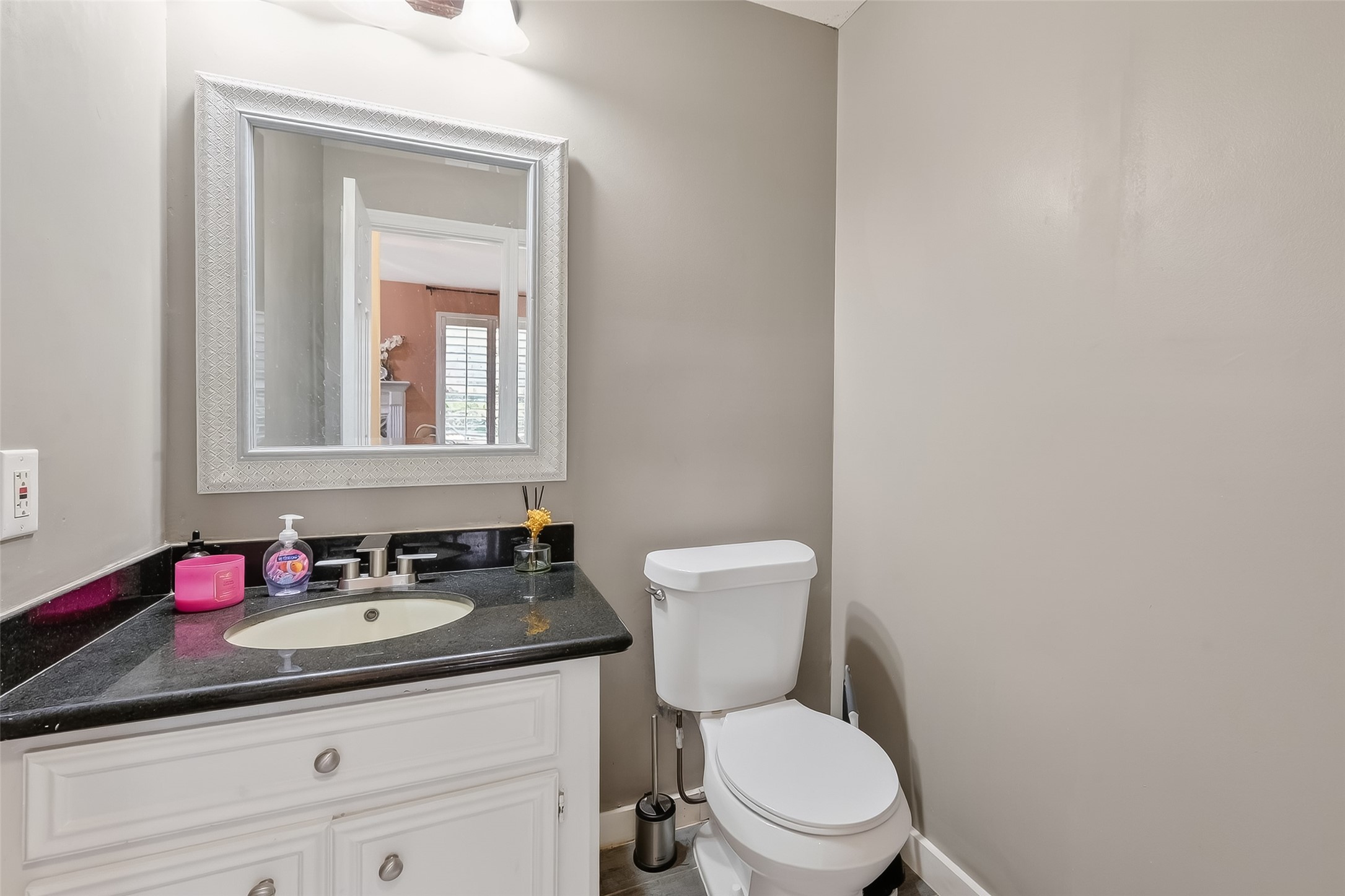 14955 Inverrary Drive Houston, TX 77095 - Photo 46 of 46 a bathroom with a granite countertop toilet sink and mirror