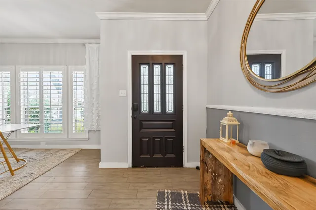 a living room with furniture chandelier and a flat screen tv