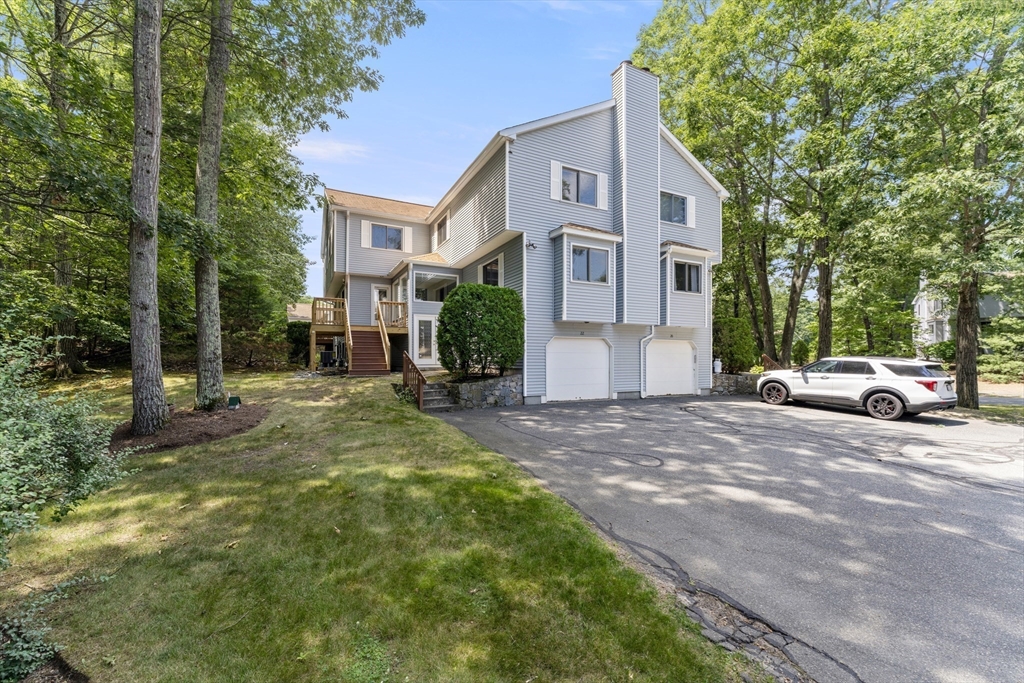 22 Arrowhead Circle, Unit 22 Ashland, MA 01721 - Photo 34 of 35 a view of a brick house with many windows and yard