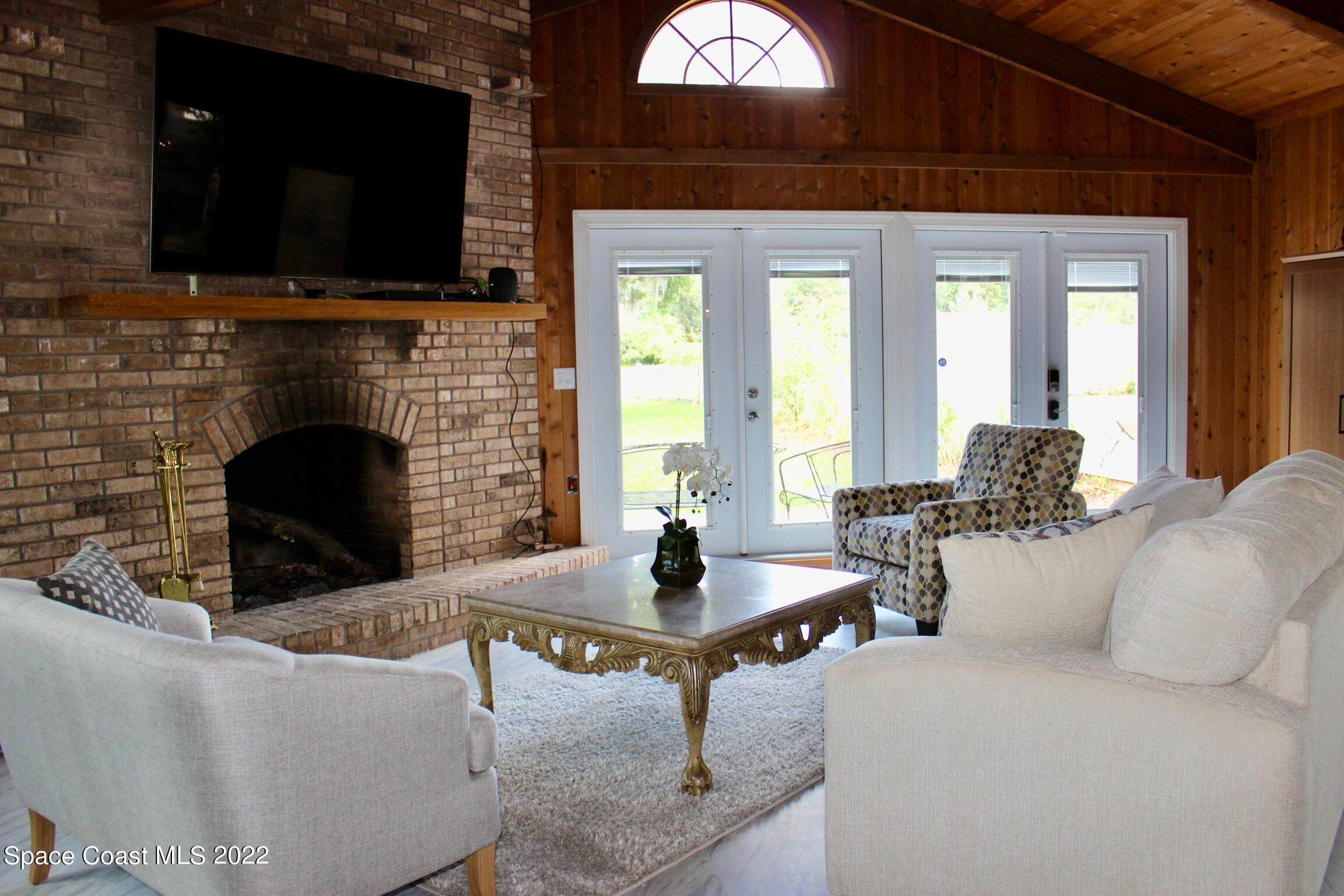 3665 Burkholm Road Mims, FL 32754 - Photo 12 of 62 a living room with fireplace furniture and a flat screen tv
