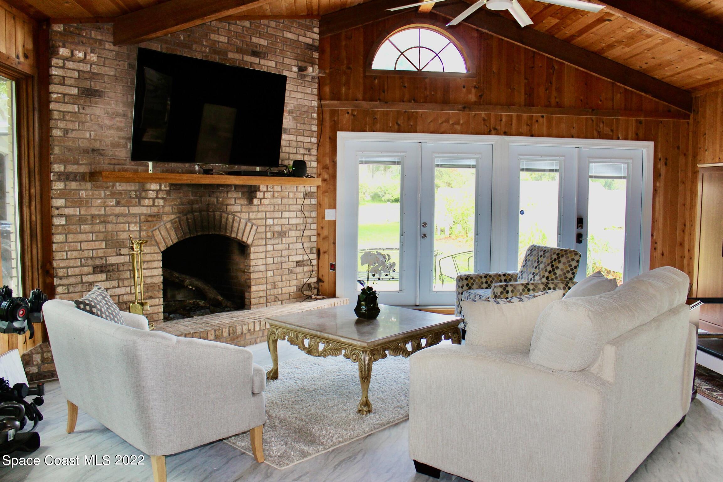 3665 Burkholm Road Mims, FL 32754 - Photo 13 of 62 a living room with fireplace furniture and a flat screen tv