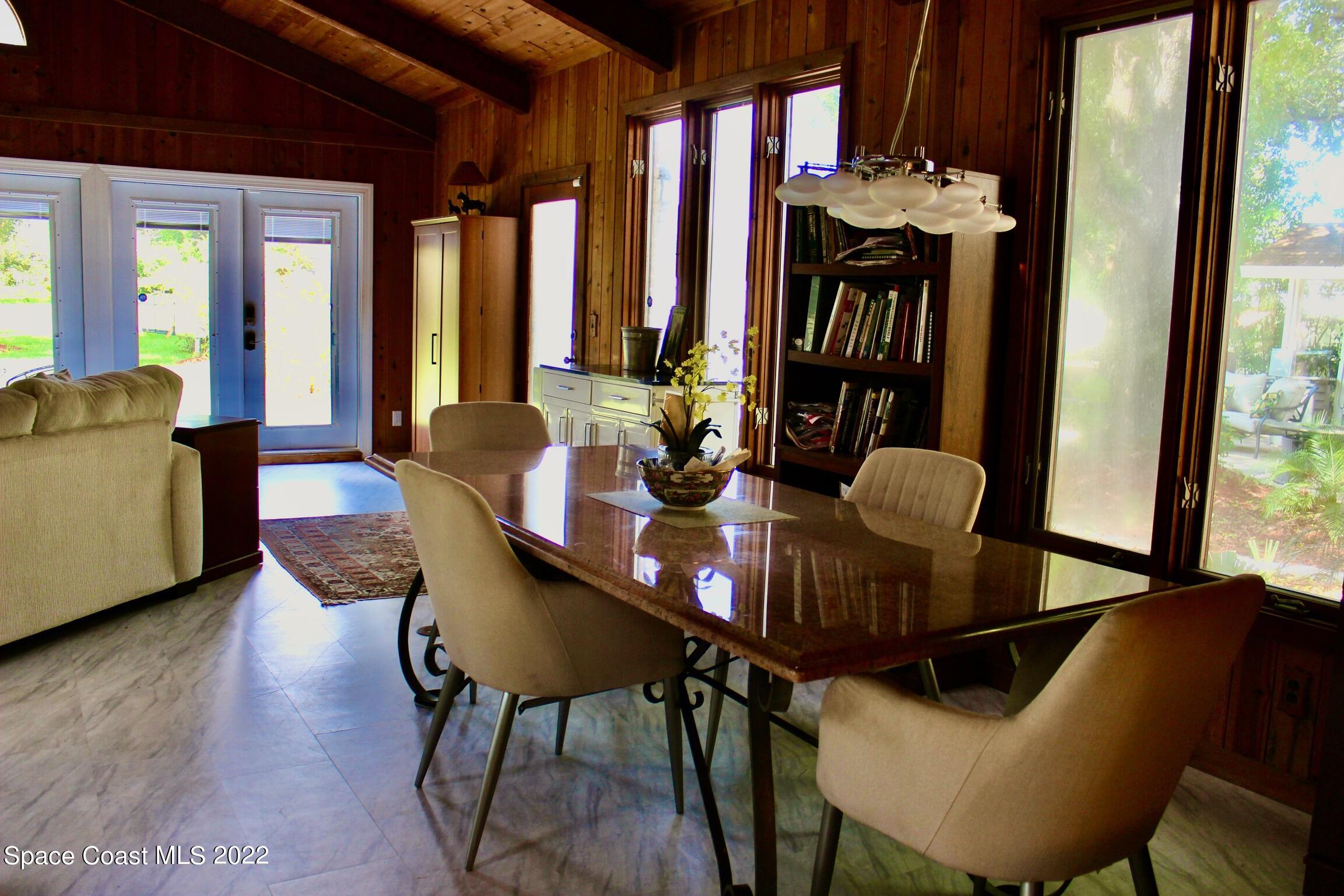 3665 Burkholm Road Mims, FL 32754 - Photo 14 of 62 a view of a dining room with furniture and a chandelier