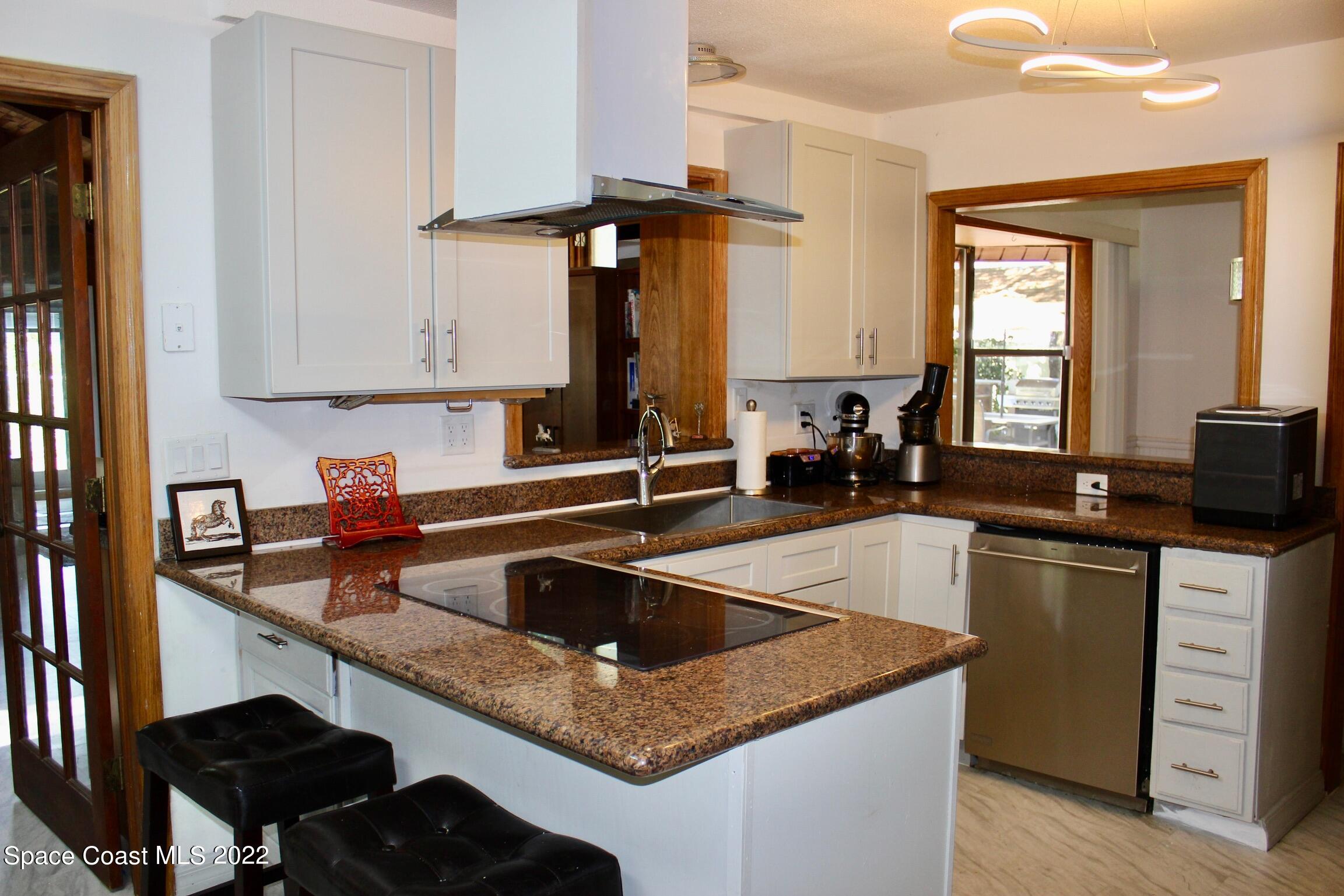 3665 Burkholm Road Mims, FL 32754 - Photo 15 of 62 a kitchen with stainless steel appliances granite countertop a sink a stove and a microwave