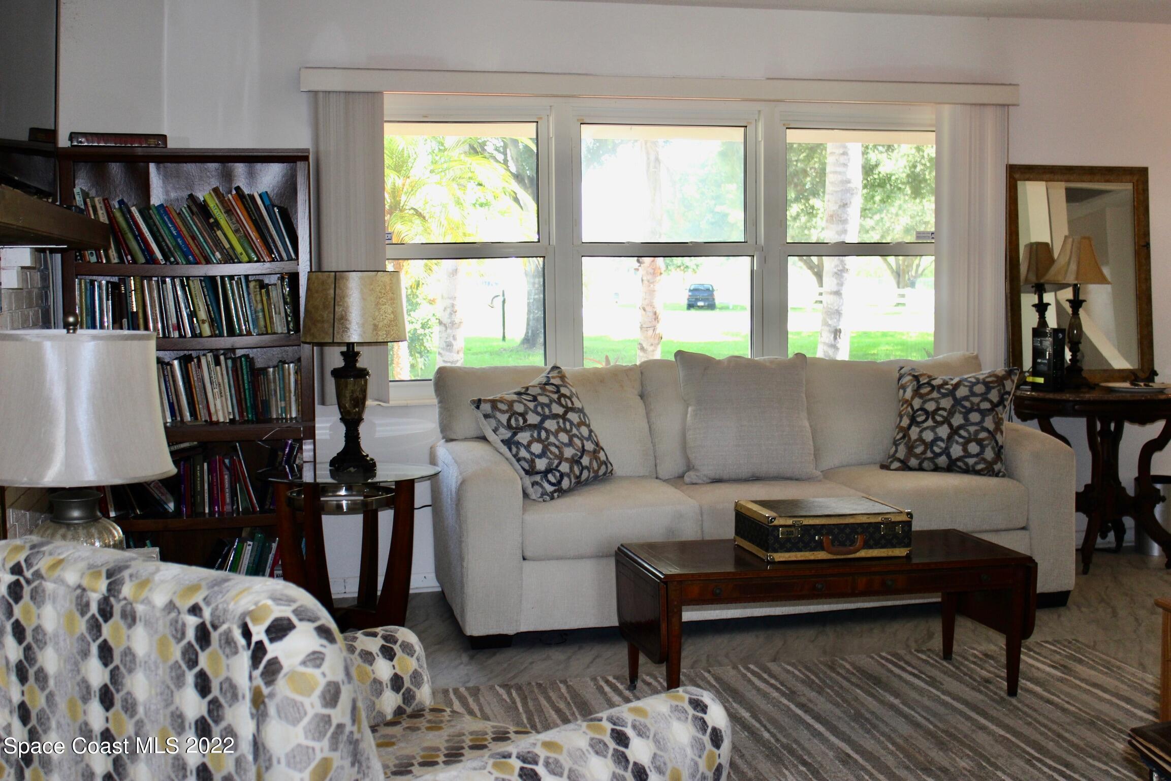 3665 Burkholm Road Mims, FL 32754 - Photo 20 of 62 a living room with furniture and a book shelf