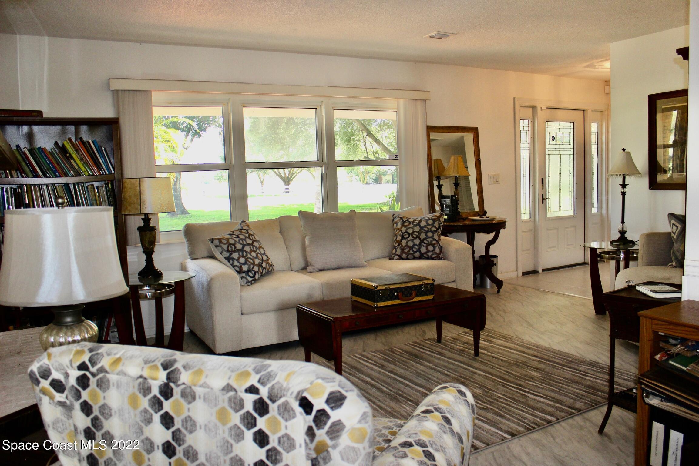 3665 Burkholm Road Mims, FL 32754 - Photo 21 of 62 a living room with furniture and two window