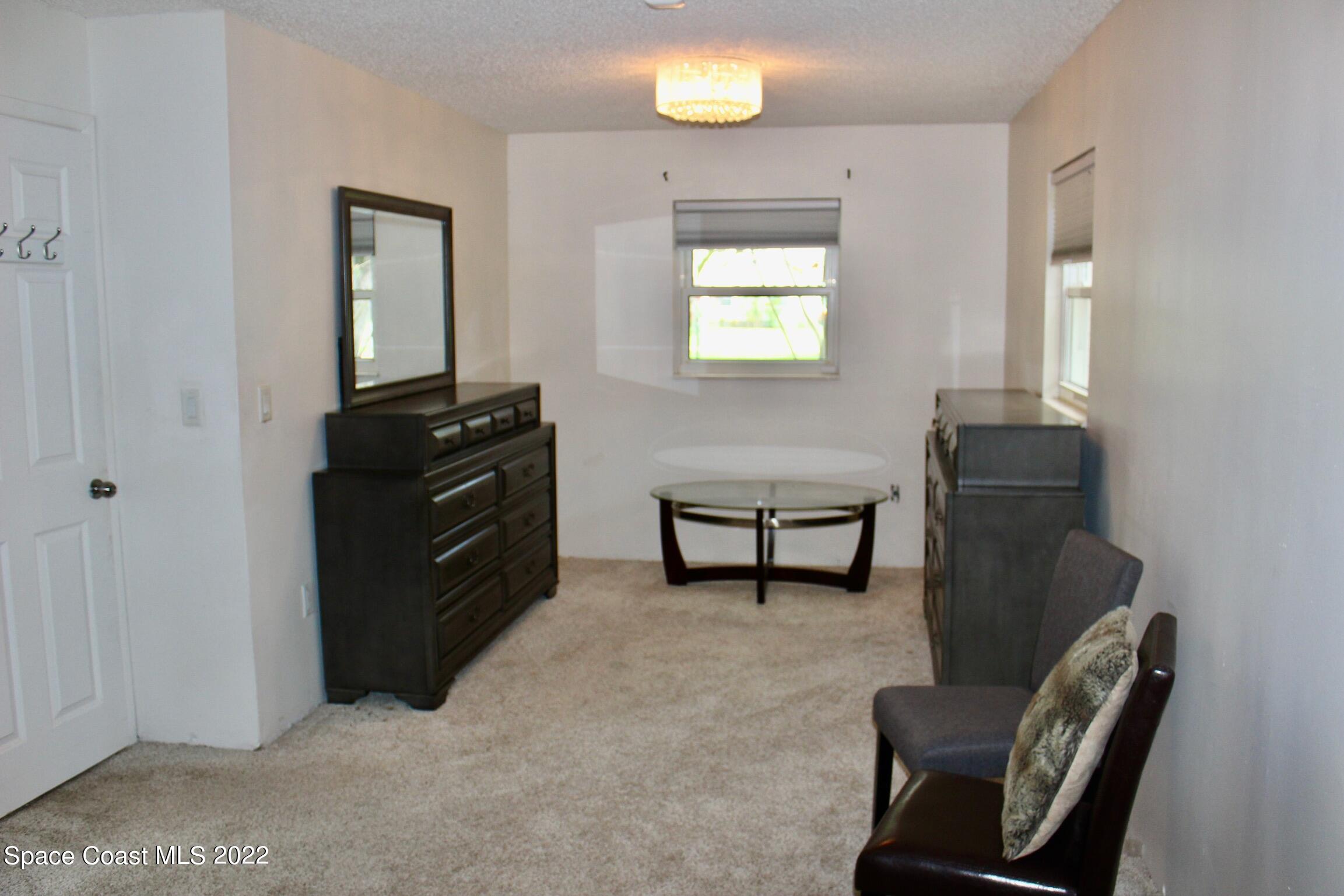 3665 Burkholm Road Mims, FL 32754 - Photo 26 of 62 a living room with furniture and a dresser