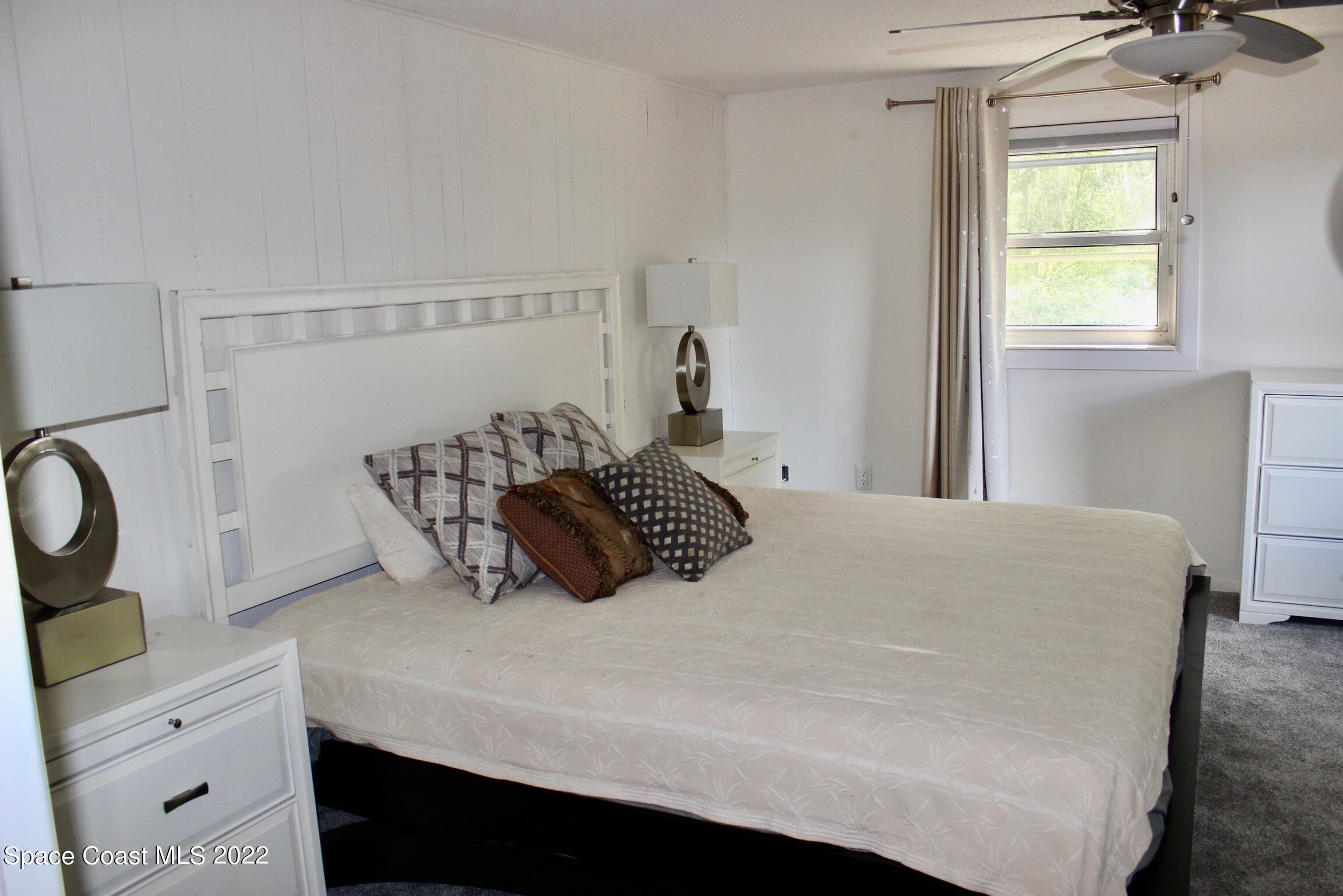 3665 Burkholm Road Mims, FL 32754 - Photo 30 of 62 a bedroom with a bed and window