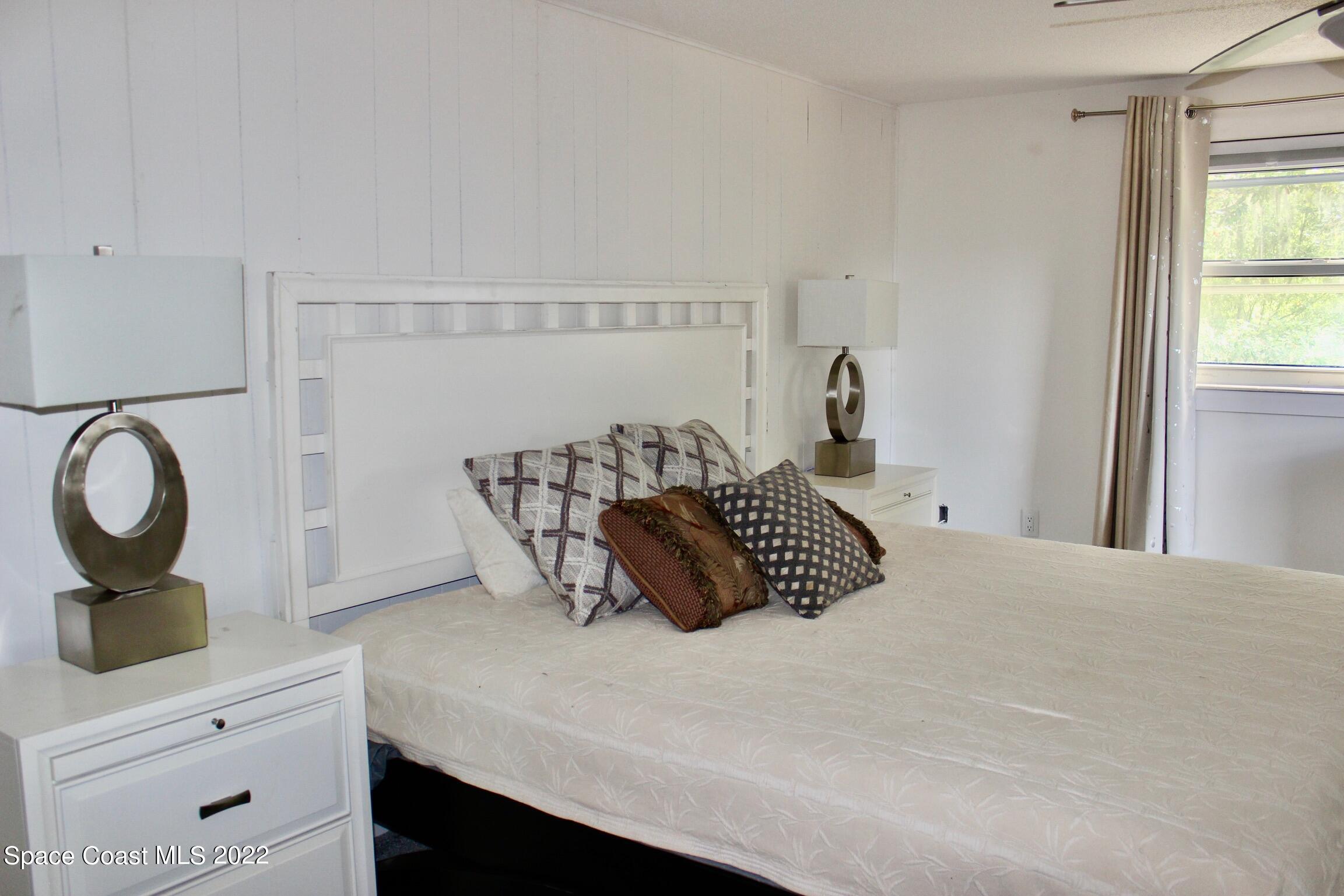 3665 Burkholm Road Mims, FL 32754 - Photo 31 of 62 a bedroom with a bed and cabinets