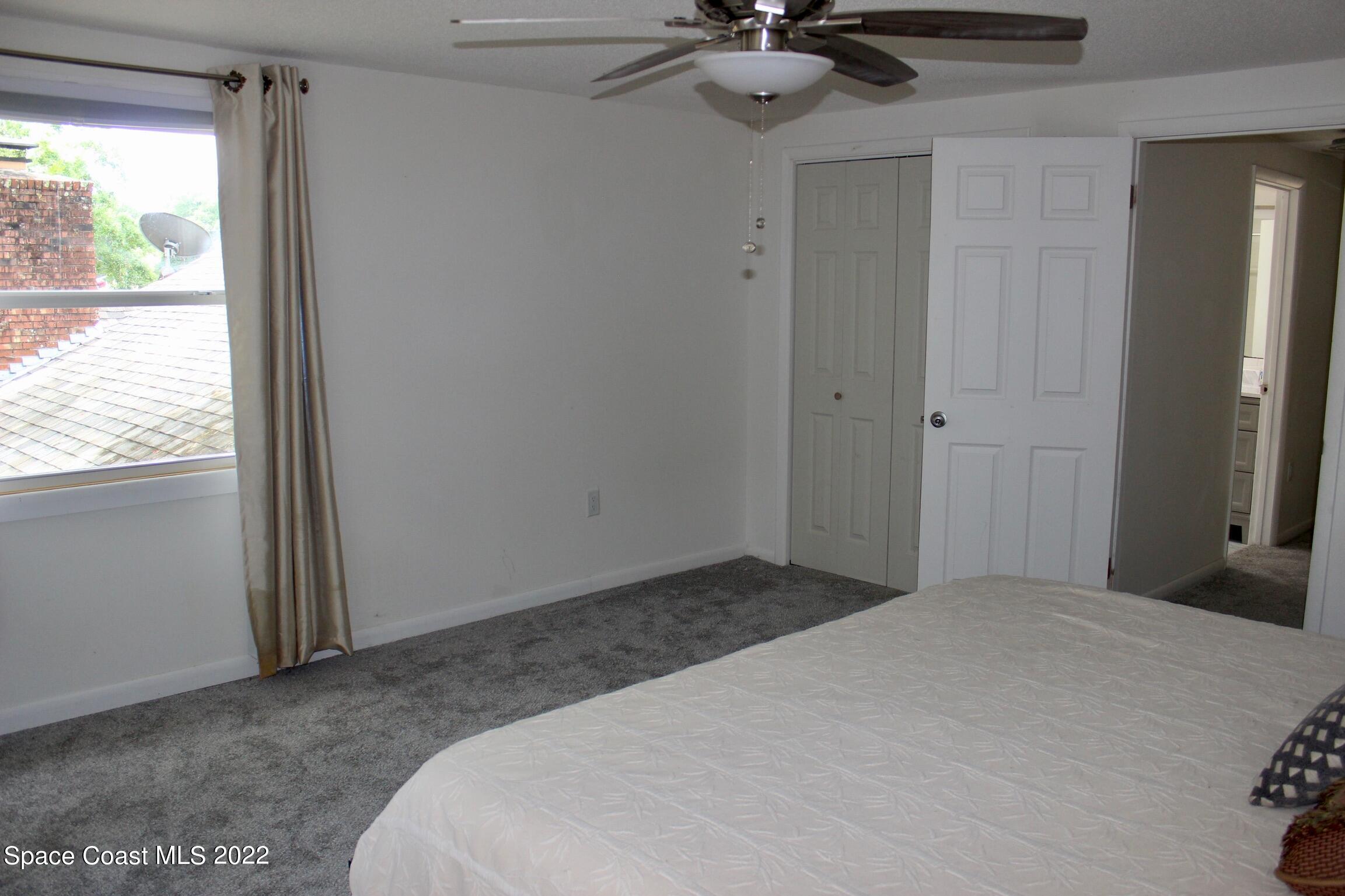 3665 Burkholm Road Mims, FL 32754 - Photo 33 of 62 a bedroom with a bed and a chandelier