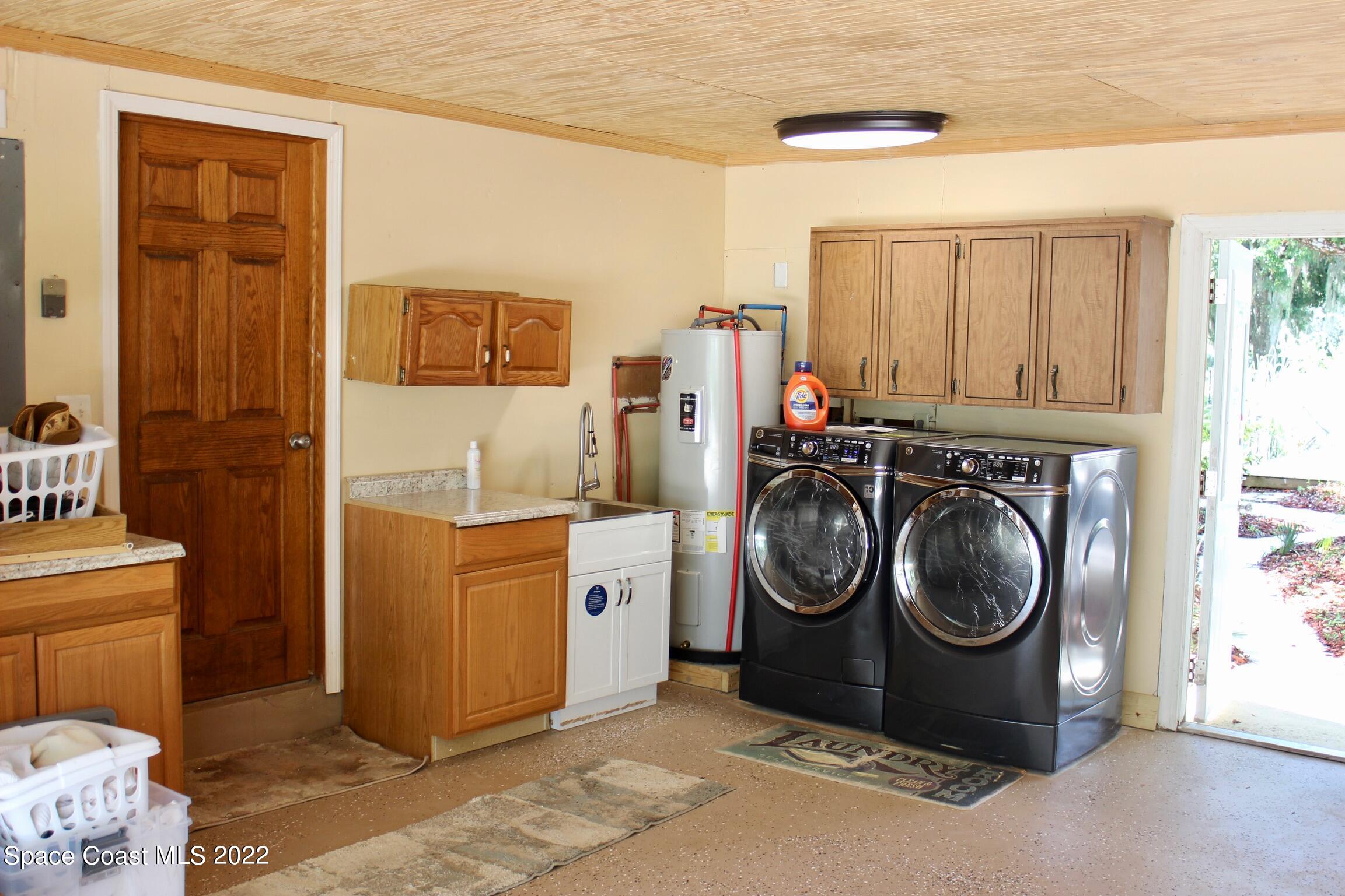 3665 Burkholm Road Mims, FL 32754 - Photo 37 of 62 a utility room with sink dryer and washer