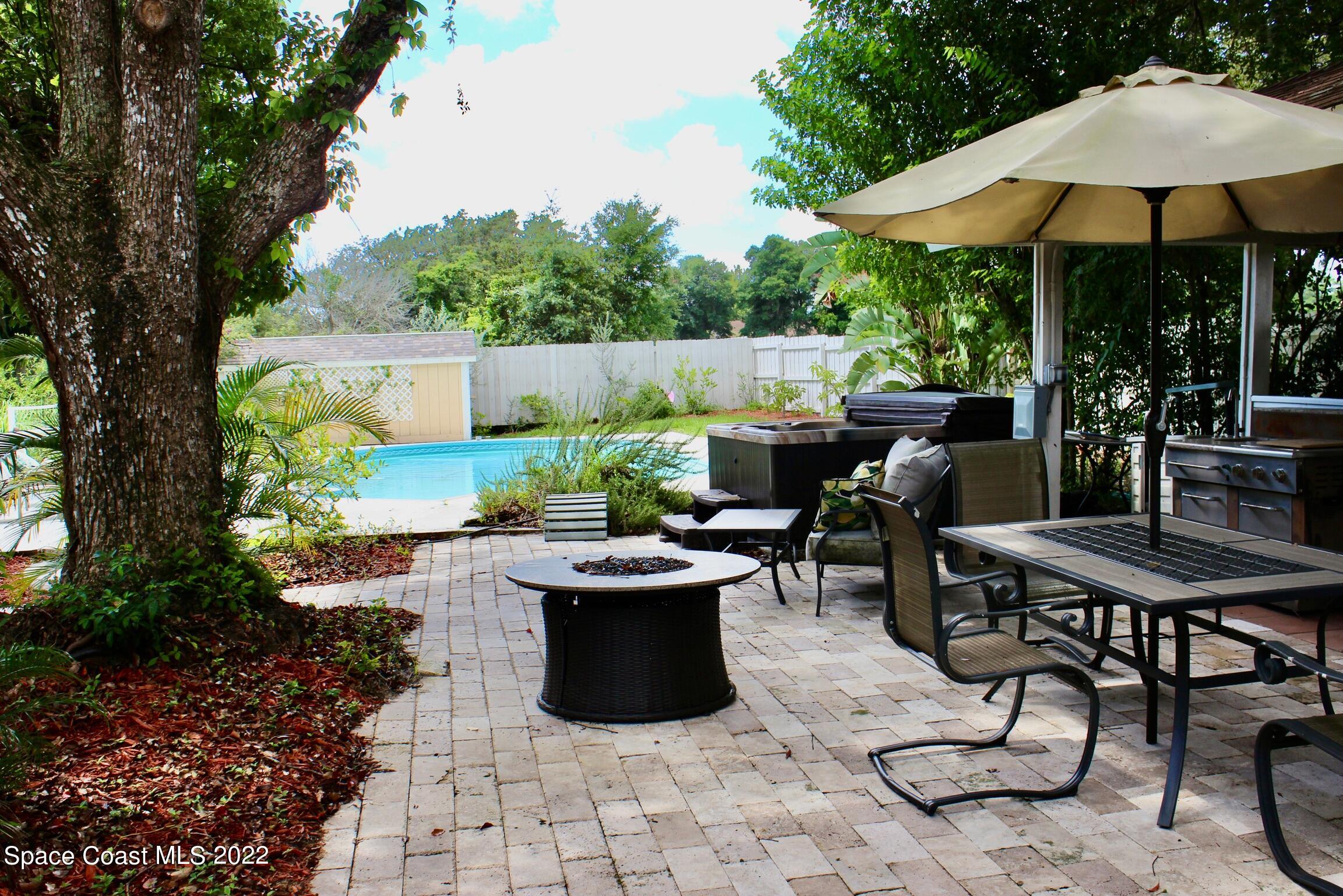 3665 Burkholm Road Mims, FL 32754 - Photo 45 of 62 a view of an outdoor sitting area with couch and umbrella