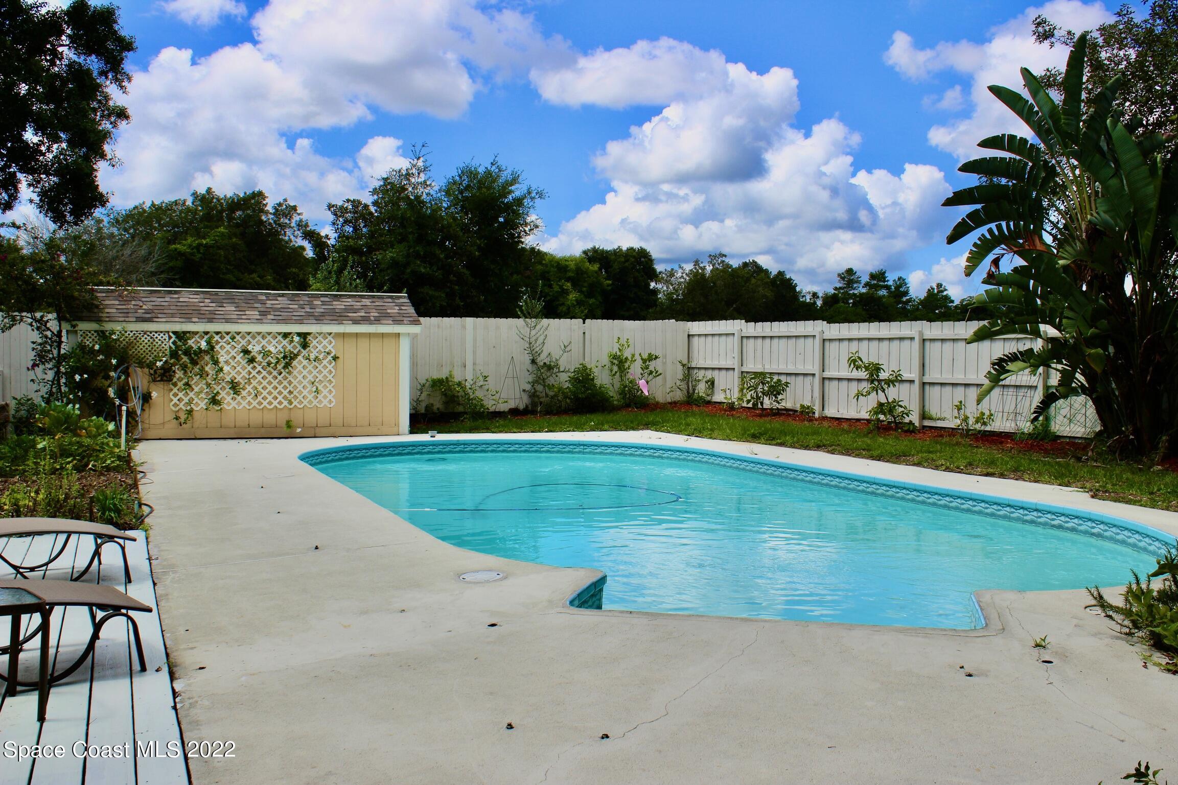 3665 Burkholm Road Mims, FL 32754 - Photo 46 of 62 a view of swimming pool with a yard