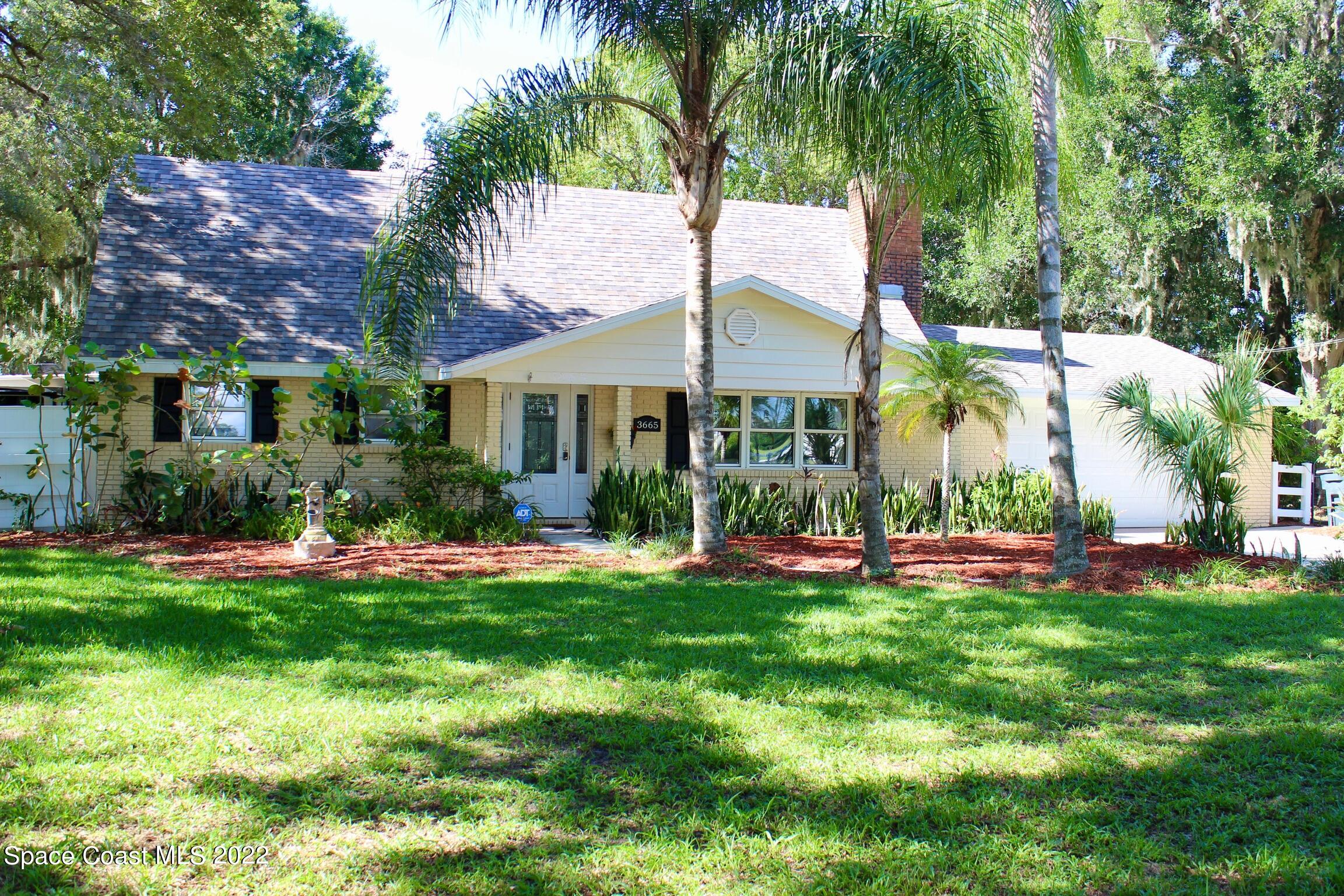 3665 Burkholm Road Mims, FL 32754 - Photo 5 of 62 a view of a house with a yard and sitting area