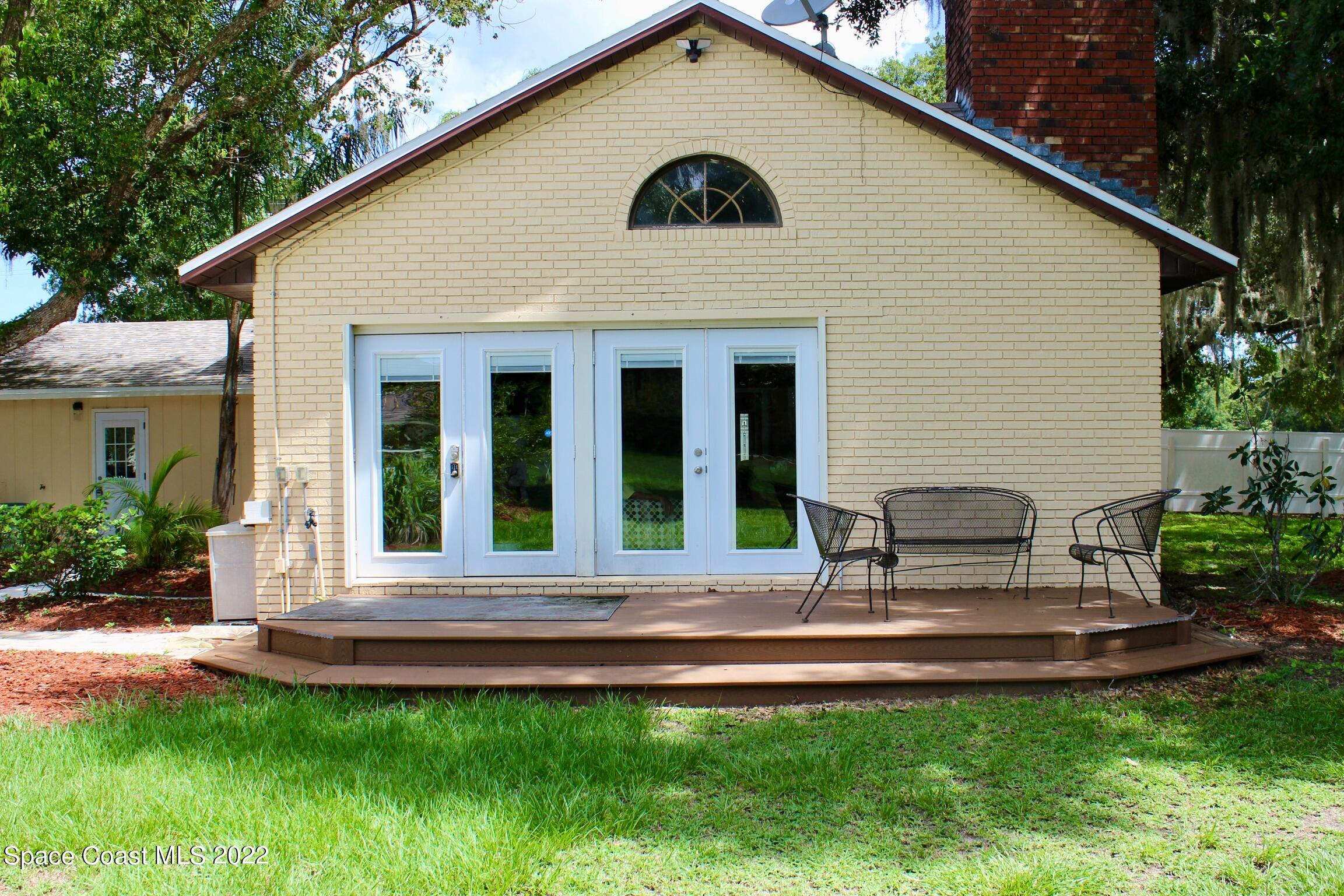 3665 Burkholm Road Mims, FL 32754 - Photo 51 of 62 a view of a house with a yard and sitting area