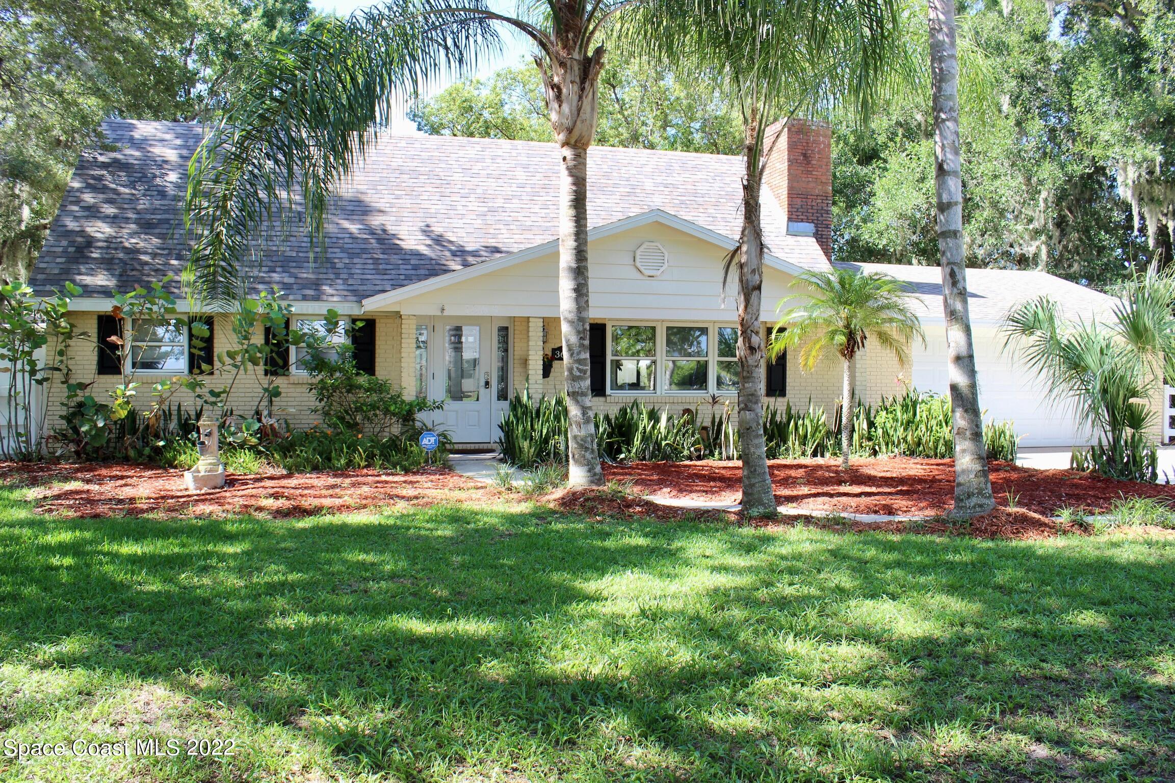 3665 Burkholm Road Mims, FL 32754 - Photo 10 of 62 a front view of house with yard and outdoor seating