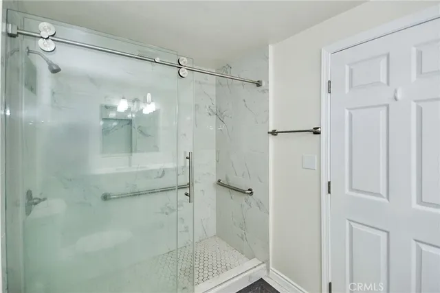 a bathroom with a glass shower door