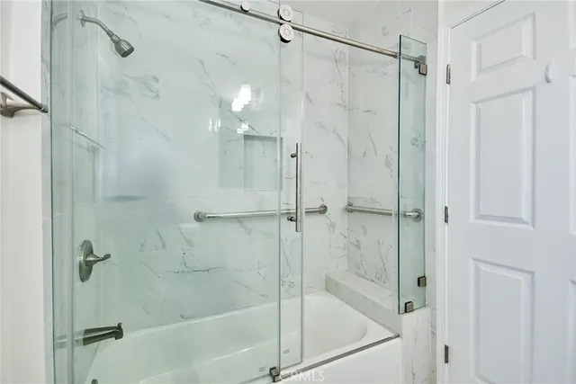 a bathroom with a shower and a bath tub