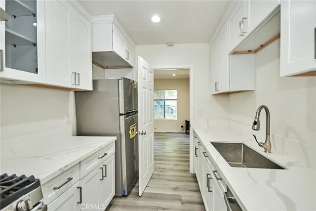 a kitchen with stainless steel appliances a refrigerator and a sink