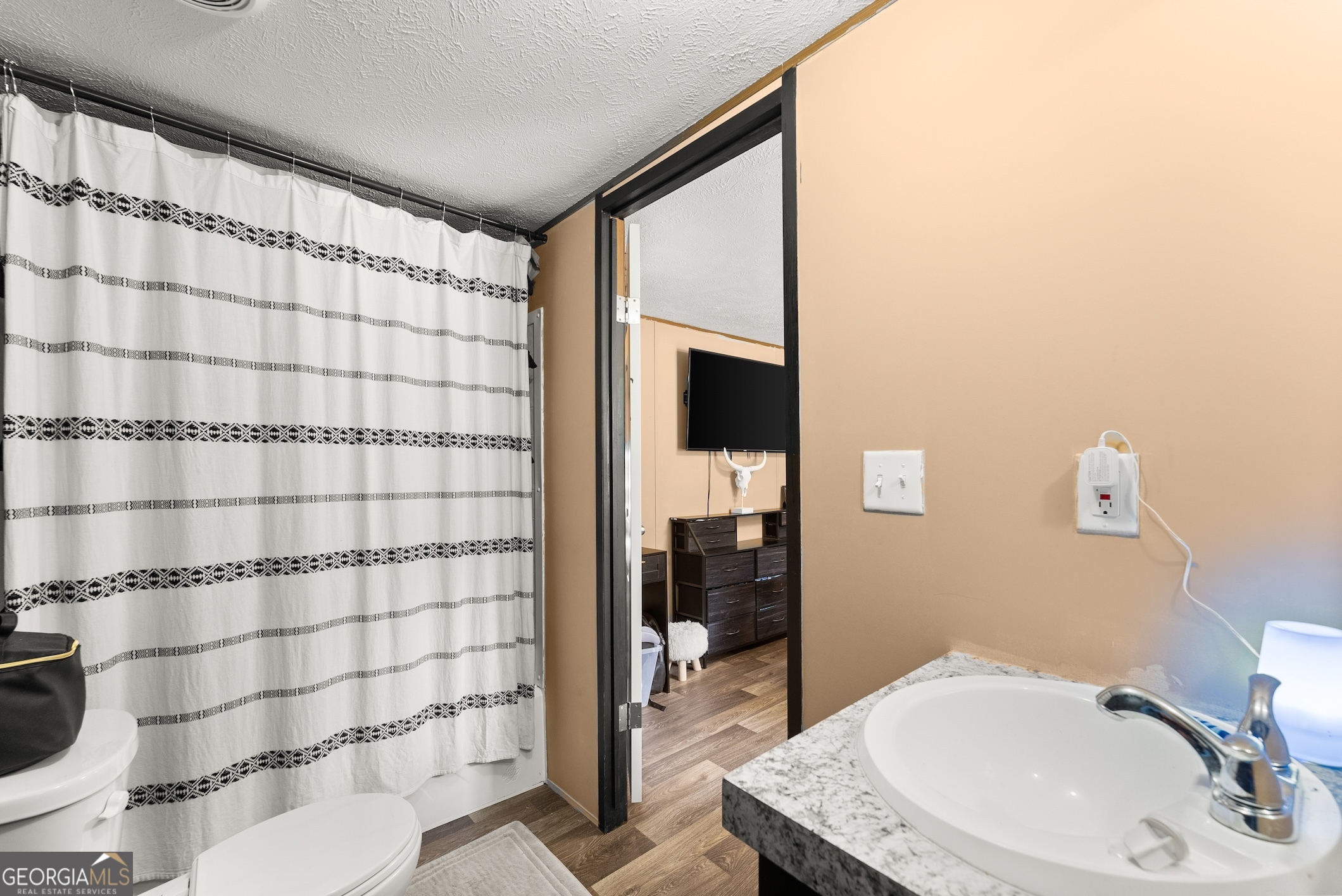 303 Blakely Chappelear Road Martin, GA 30557 - Photo 11 of 20 a bathroom with a sink toilet and shower